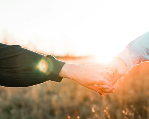 two person holding each other's hands
