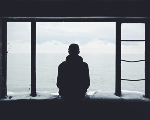 person looking out through window