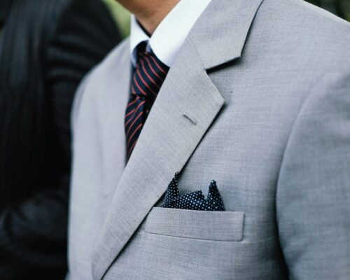 man wearing gray notched lapel suit jacket standing
