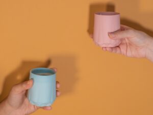 A woman holding a pink and blue cup