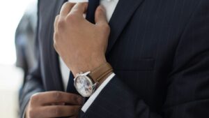 man wearing watch with black suit