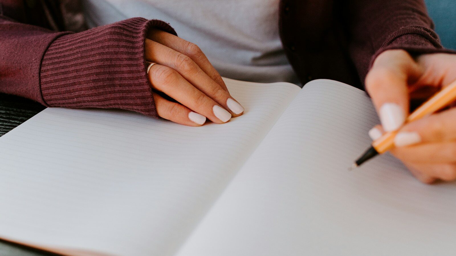 person writing on white paper