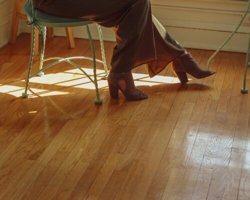 person sitting on green metal chair