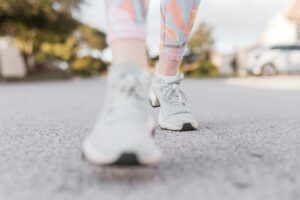 person in white nike sneakers