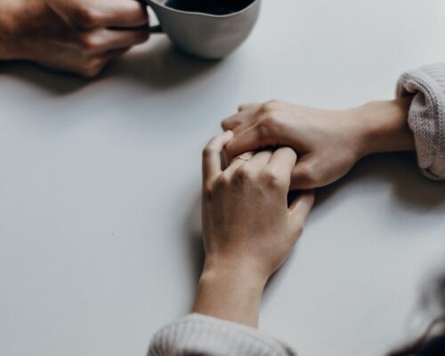 person holding black ceramic mug